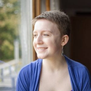 Headshot of a smiling white woman with short brown hair